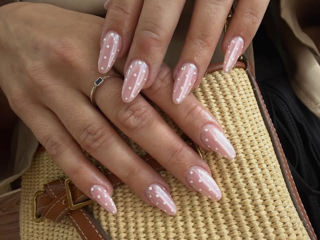 Soft pink nail art with white dots, photographed by Pink Nails Horsforth