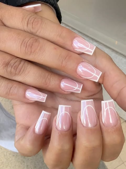 Pale pink square nails with curved white nail art